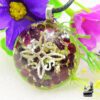 Pendentif Orgonite artisanal en résine transparente avec éclats de Grenat rouge, copeaux d'aluminium et symbole Nœud de Sorcière