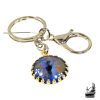 Porte-clé artisanal "Œil de Dragon" Pyros en métal argenté avec motif peint à la main, création unique de la boutique Le Trésor des Korriganes.